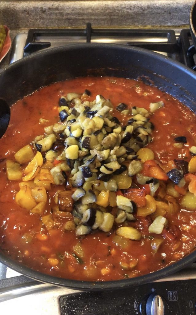 Adding aubergines and peppers
