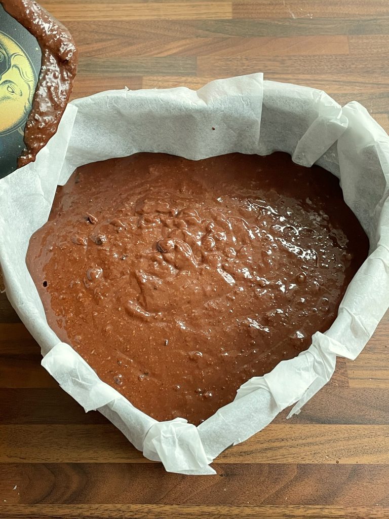 Prepare the cake tin while preheating the oven